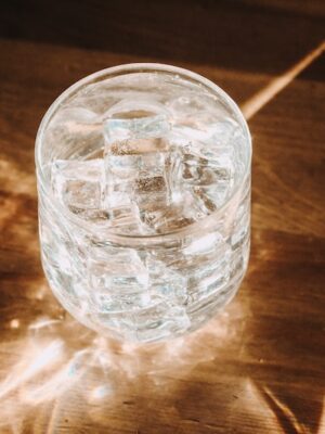 clear glass cup on brown wooden table